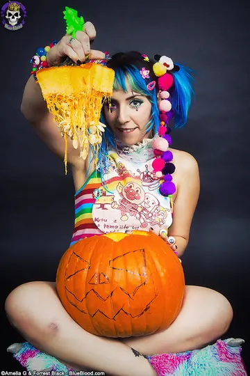 Woman with Pigtails Strips While Carving a Pumpkin and Spreads