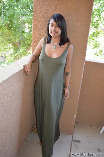 Ebony Woman Undresses and Shows Her Hairy Pussy