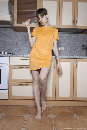 Amelinda – Short-Haired Brunette Strips Out of Her Skirt in the Kitchen