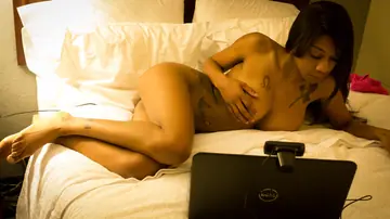 Ebony Brunette with Big Tits Spreads Her Shaved Pussy on the Bed