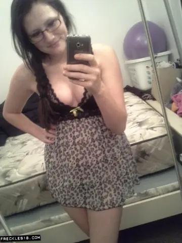 Busty Brunette in Glasses Spreads Her Pussy in Lingerie Selfie