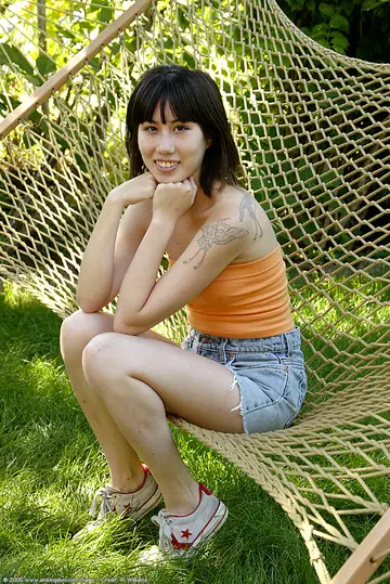 Asian Woman Pulls Panties Aside to Spread Her Hairy Pussy Outdoors