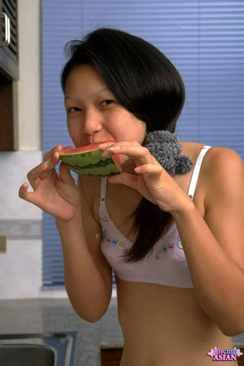 Lin Si Yee: Thai Brunette Eats Watermelon and Strips in the Kitchen – photo 3 of 16