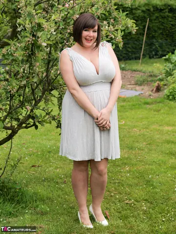 British MILF in a Skirt Shows Her Large Tits in the Garden