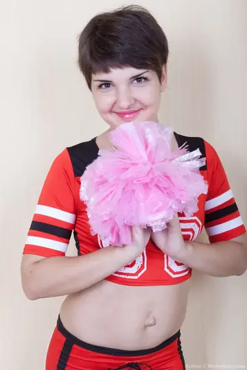 Rubina – Short-Haired Brunette in Cosplay Uniform Strips and Spreads Her Hairy Pussy