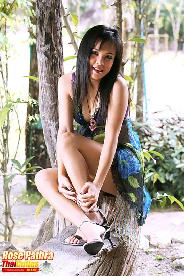 Thick Asian Woman in a Skirt and Heels Spreads Her Pussy by a Tree