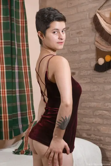 Tattooed Brunette Strips in the Bedroom Showing Hairy Armpits and Ass