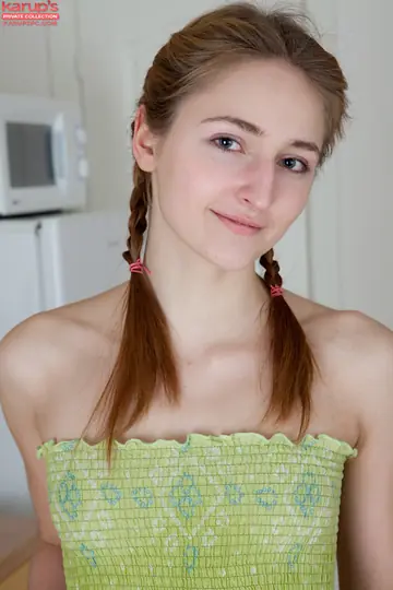 Woman in Pigtails Lifts Her Skirt to Finger Her Hairy Pussy in the Kitchen