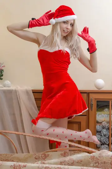 Blonde in Santa Cap and Skirt Bares Her Pussy