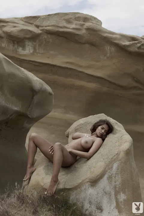 Clarencia Niamat: Busty Latina Poses Nude on a Rock Outdoors – photo 11 of 14