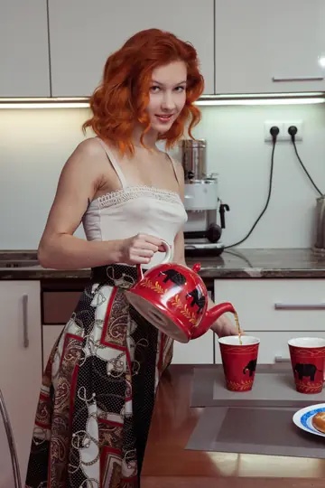Slim Curly Woman Spreads Her Pussy in the Kitchen