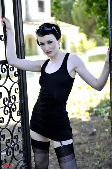 Brunette with Short Hair Poses in a Skirt, Panties and High Heels