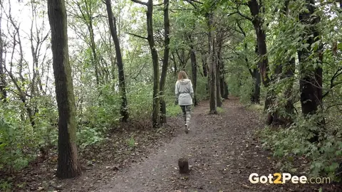 Woman Pulls Down Pants and Pees in the Forest – photo 14 of 15