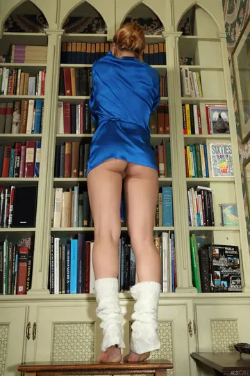 Petite Redhead in Socks Rides a Toy on the Floor Mirror