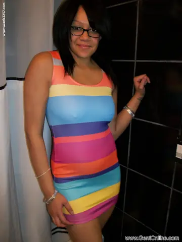 Latina Amateur with Big Tits Poses in a Skirt and Glasses for a Selfie
