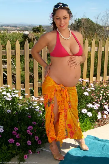 Pregnant MILF in a Bikini and Glasses Spreads Outdoors
