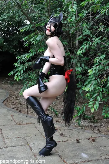 Busty Brunette in Latex and Leather Poses Bound Outdoors