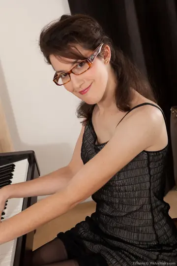 Short-Haired Hairy Woman in Glasses Spreads at the Office Piano