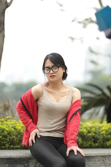 Asian Brunette in Glasses Poses Outdoors
