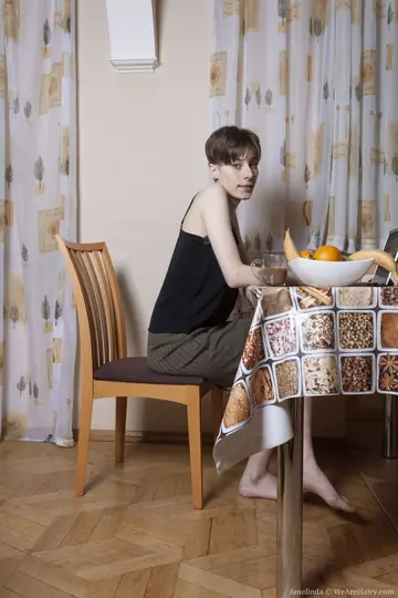 Amelinda – Tall Skinny Brunette Spreads Her Hairy Pussy on a Chair