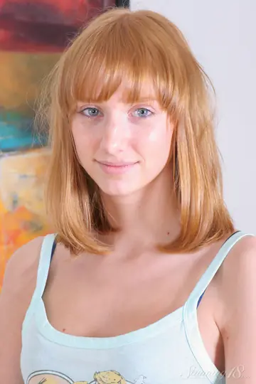 Redhead Strips Out of Her Panties on a Leather Sofa