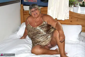 British Silver-Haired BBW Masturbates with a Dildo on the Bed