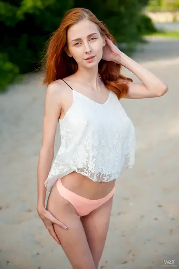 Slim European Redhead Flashes Her Big Natural Tits on the Beach