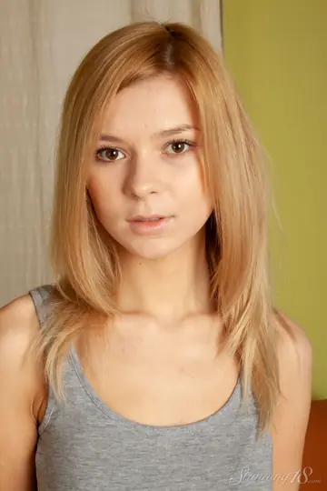 Lolly Hardcore – Blonde in Socks Shows Off Her Shaved Pussy on the Sofa