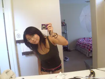 Asian Woman with Big Tits Pulls Panties Aside in Selfie