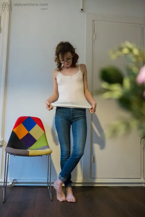 Emma Evins: Redhead in Glasses Pulls on Jeans and Panties After Nude Modeling – photo 16 of 16