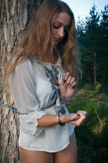 Blonde Lesbian in Bondage Plays with Hairy Pussy in the Forest