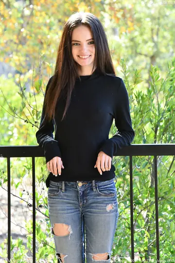 Skinny Brunette in Jeans Spreads on the Balcony
