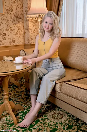 Lolla Elfie – Slim Blonde Displays Her Shaved Pussy and Ass on the Sofa