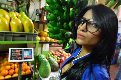 Marly Romero: Tattooed Latina in Glasses Eats a Banana Outdoors – photo 15 of 15