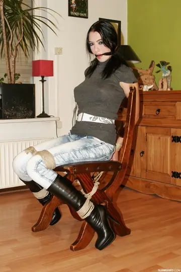 Brunette in Jeans and Heels Tests Restraints While Tied to a Chair