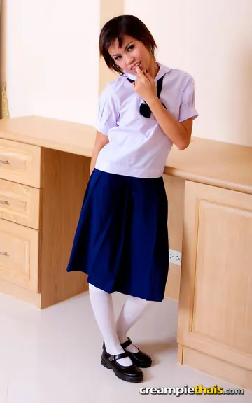 Thai Brunette Peels Off Her Uniform and Rubs Her Trimmed Pussy