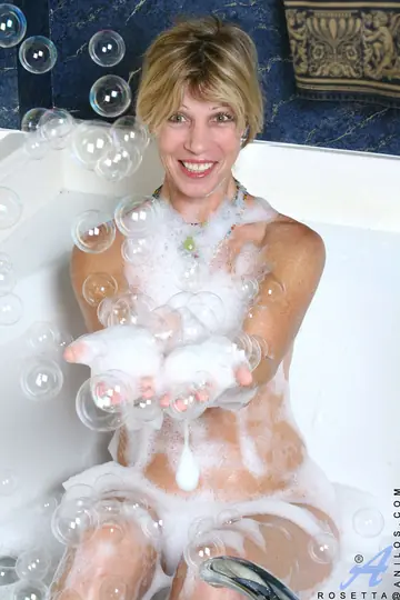 Busty Mature Woman Fingers Her Hairy Pussy in a Bubble Bath