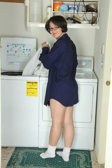 Tattooed Brunette MILF Undresses in Laundry Room Keeping Glasses On