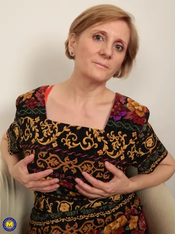 Mature European Slips Out of Her Dress to Reveal Lingerie