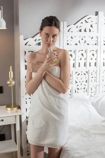 Woman with Natural Tits Oils Her Shaved Body and Spreads