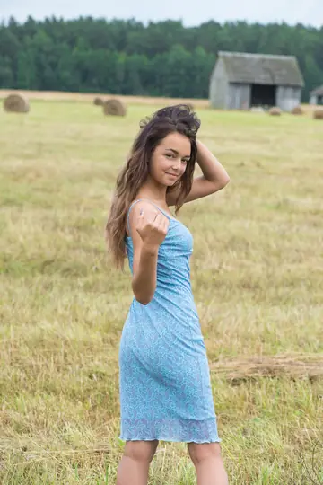 Brunette Strips Out of Her Dress on Hay in a Forest
