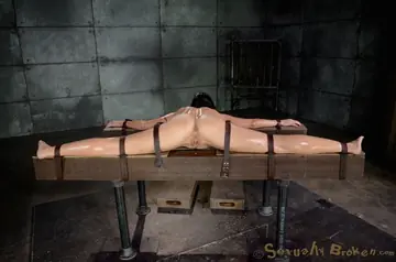 Wenona – Tall Brunette MILF Bound on Wooden Cross for Interracial Threesome