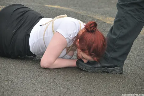 Thick Redhead Licks Boots and Crawls in Restraints Outdoors – photo 12 of 16