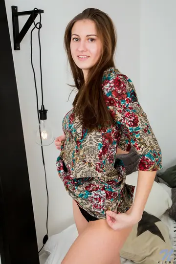 Woman Strips on Her Bed and Reveals Her Shaved Pussy