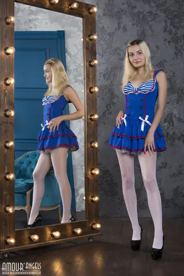 Blonde Strips Out of Her Skirt and Pantyhose Before a Mirror