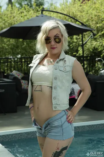 Violet Revolver – Short-Haired Blonde in a Bikini and Glasses Strips by the Pool
