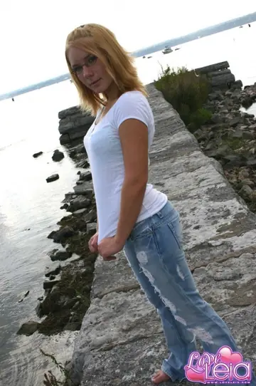 Blonde with Big Tits Strips Out of Her Ripped Jeans on the Beach