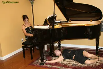 Brunette Dominates Restrained Woman in Stockings and Heels