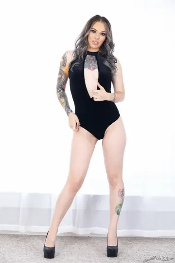 Curly Tattooed Babe Peels Off Her Black Bodysuit
