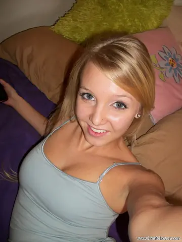 Busty Blonde Spreads Her Shaved Pussy on the Bed